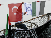 israel turkey A demonstrator burns an Israeli flag as he sits between Turkish (L) and Palestinian flags during a protest against Israel on June 5, 2010 at Caglayan Square in Istanbu
