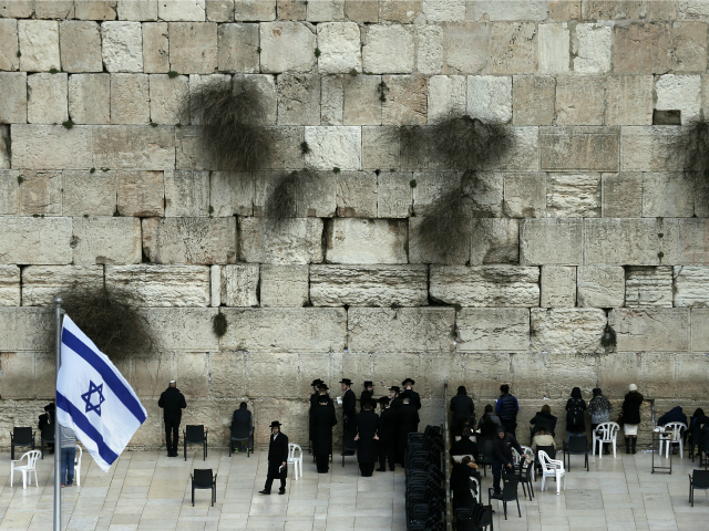 Ultra-Orthodox Jewish men (L) and women (R) pray in two different sections at the Western Wall, the most holy site where Jews can pray, in Jerusalem's Old city, on February 2, 2016.