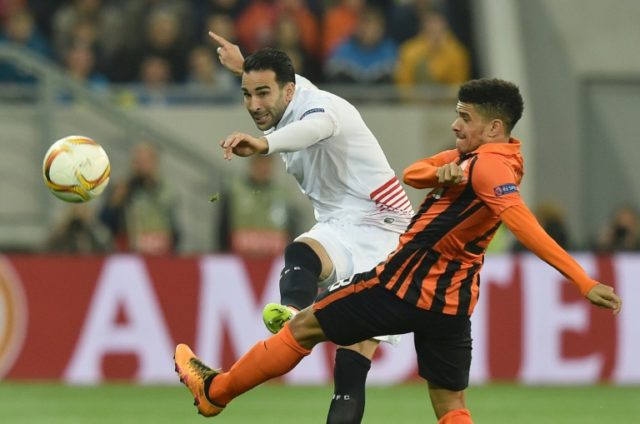 Taison (R) of FC Shakhtar vies for a ball with Adil Rami (L) of Sevilla FC during the UEFA