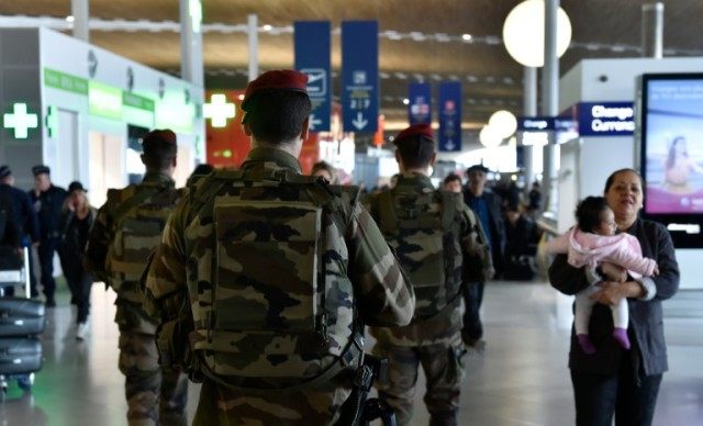 French soldiers patrol inside the departure terminal of the Charles de Gaulle Airport in R