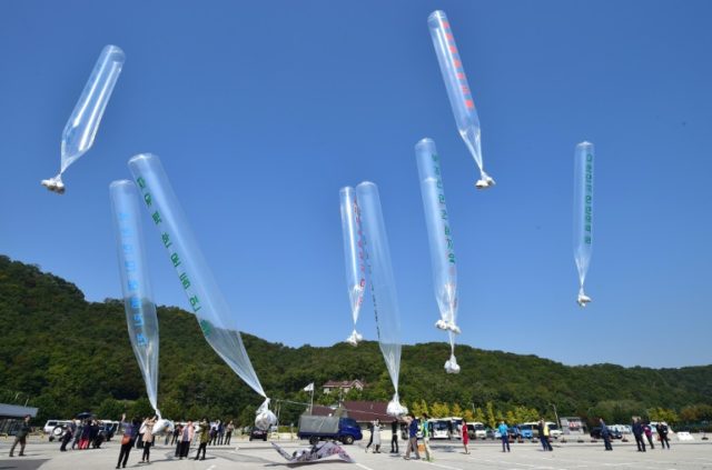 South Korean activists release balloons carrying anti-North Korea leaflets at a park near
