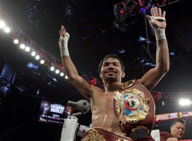 Manny Pacquiao gestures to fans after defeating Timothy Bradley in a 12-round unanimous de