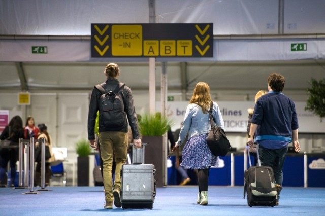 Passengers arrive at a temporary check-in area at Brussels airport after it reopened follo