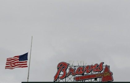 An American flag is lowered to half-staff at Turner Field in memory of a fan, Greg Murrey,