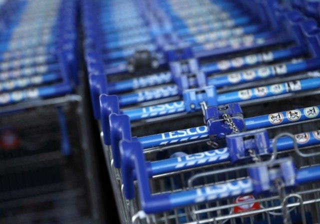 British supermarket giant Tesco says it has rebounded into slender annual net profits