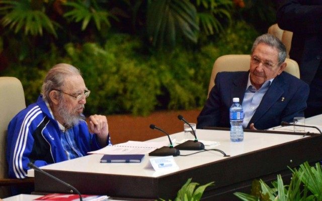 Cuban President Raul Castro (R) listens as his older brother and former president Fidel Ca
