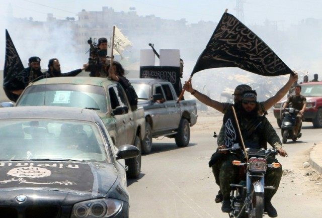 Fighters from Al-Qaeda's Syrian affiliate Al-Nusra Front patrol the northern city of Alepp
