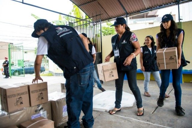 Employees of Peru's National Office of Electoral Processes (ONPE) arrange electoral materi