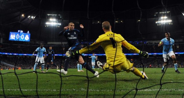 Manchester City's English goalkeeper Joe Hart (CR) saves a close-range shot from Real Madr