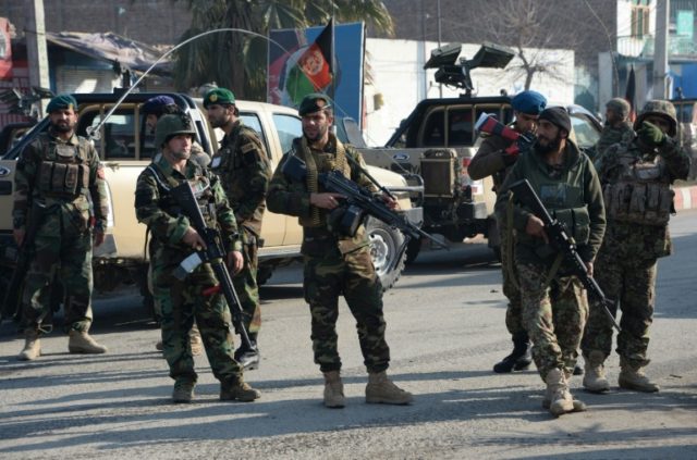 Afghan security personnel stand guard in Jalalabad