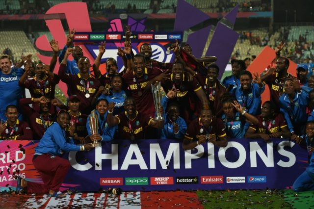 West Indies's Darren Sammy(C)leads teammates and members of the West Indies women's team a
