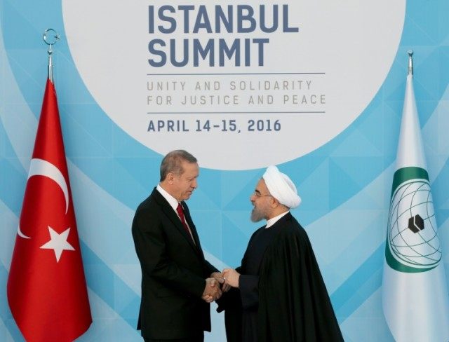 Turkish President Recep Tayyip Erdogan (left) greets Iranian President Hassan Rouhani at t