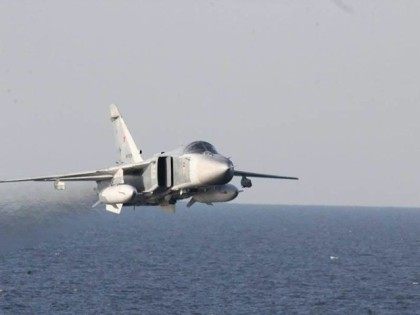 A Russian Su-24 warplane flies over the USS Donald Cook in the Baltic Sea