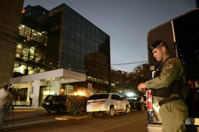 Police stand guard outside the Mossack Fonseca law firm offices in Panama City during a ra