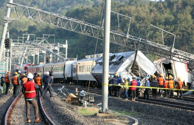 South Korea railway workers struggle to put a derailed passenger train back on track in th