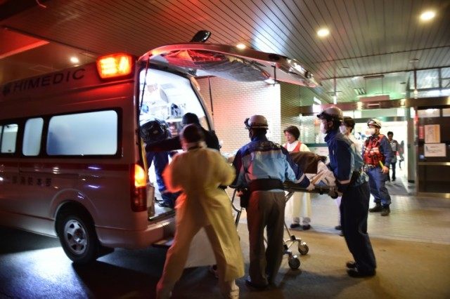 A patient is evacuated by emergency staff from an hospital in Kumamoto City on April 16, 2