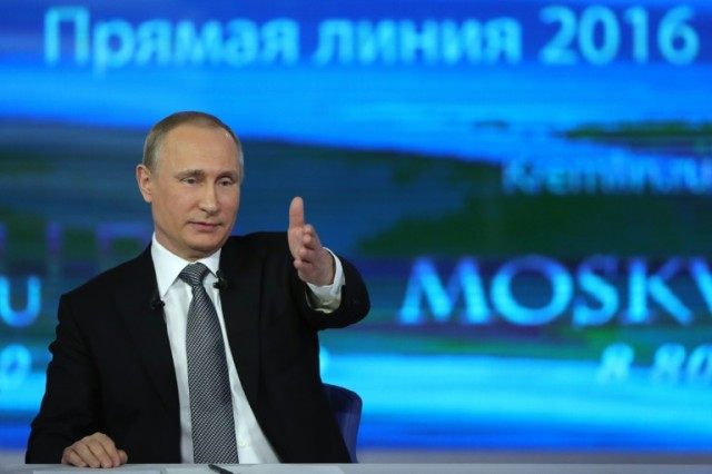 Russian President Vladimir Putin answers questions during his annual televised phone-in wi
