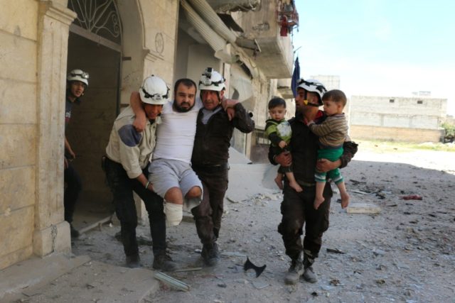 Syrian civil defence volunteers evacuate a man and children following a reported air strik