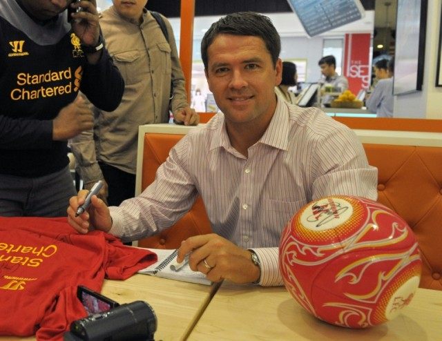 Former England footballer Michael Owen signs autographs during a private event at the Wism