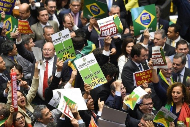 Brazilian deputies hold signs against Brazilian President Dilma Rousseff's impeachment dur