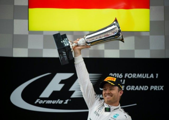 Mercedes AMG Petronas F1 Team's German driver Nico Rosberg celebrates with the trophy on t