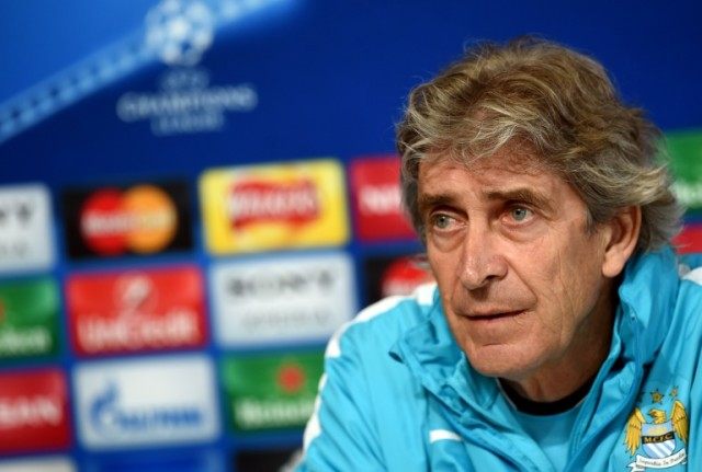 Manchester City's manager Manuel Pellegrini attends a press conference following a team tr
