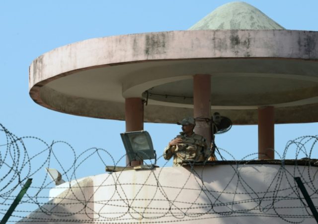 A policeman stands guard at a watchtower at New Delhi's high security Tihar Jail