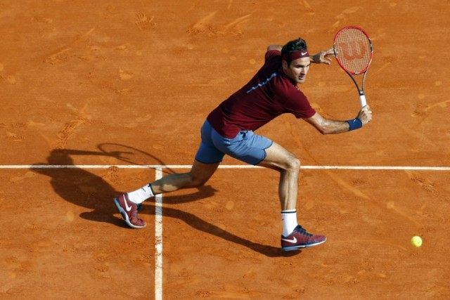 Switzerland's Roger Federer returns a backhand to Spain's Roberto Bautista Agut on April 1