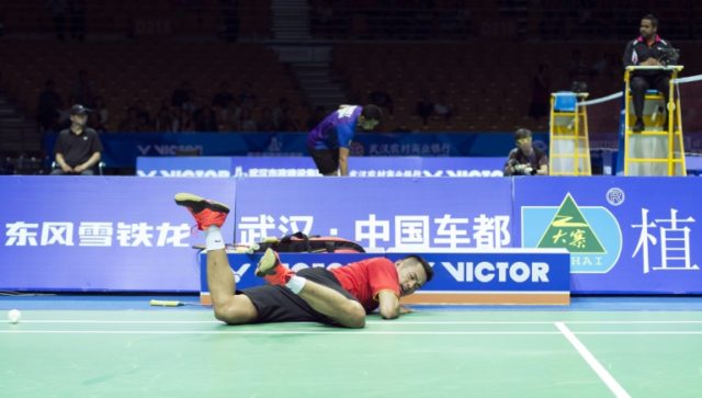 Lin Dan of China falls during his quarter-final match against Lee Dong Keun of South Korea