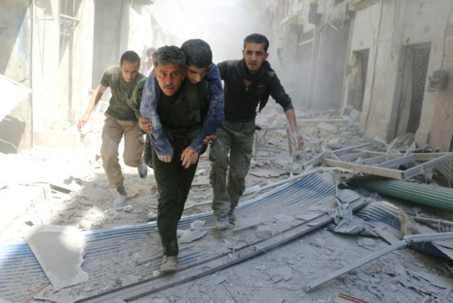 Syrians evacuate an injured man following an air strike on a rebel-held neighbourhood in t