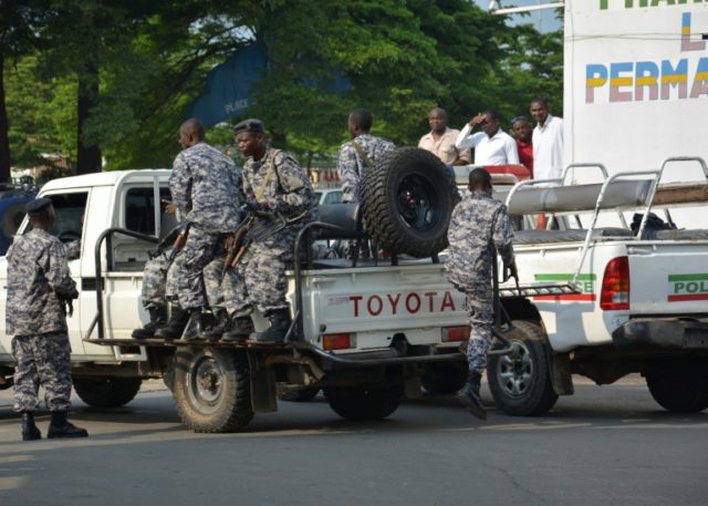 Burundi policemen patrol the street on February 15, 2016 following a grenade attack in Buj