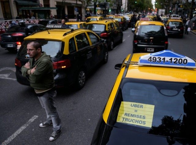 Cabs block Mayo Avenue as taxi drivers protest against Uber and what is viewed by some dri