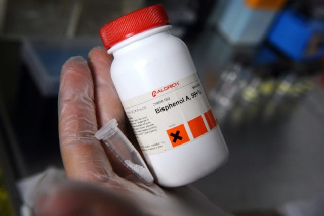 A scientist holds a flask containing the chemical Bisphenol-A, on October 9, 2012 at the F