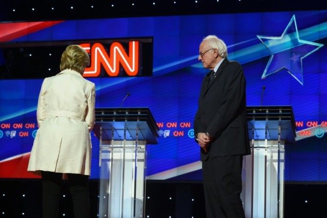 US Democratic presidential candidates Hillary Clinton (L) and Bernie Sanders attacked each
