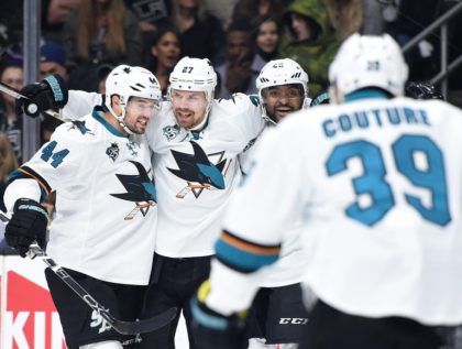 Joonas Donskoi (C) of the San Jose Sharks celebrates his goal with teammates Marc-Edouard Vlasic (L) and Joel Ward during their NHL matcg against the Los Angeles Kings, at Staples Center in Los Angeles, California, on April 22, 2016