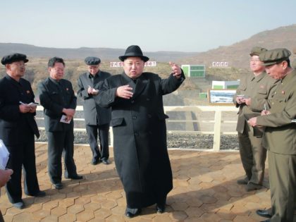 North Korean leader Kim Jong-Un (C), seen during a visit to the Paektusan Hero Youth Power Station No. 3 in Ryanggang Province
