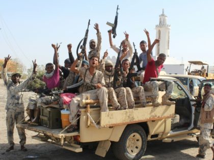 Forces loyal to the Saudi-backed Yemeni president cheer on a road in Abyan province as they take part in an operation to drive Al-Qaeda fighters out of the southern provincial capital, on April 23, 2016