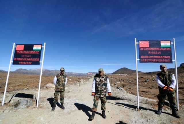 Indian military personnel guard Bumla pass on the India-China border, in north-eastern Aru