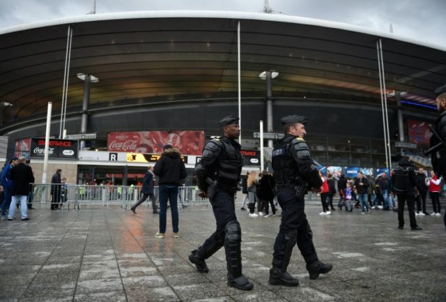 French gendarms patrol ahead of an international friendly football match outside the Stade