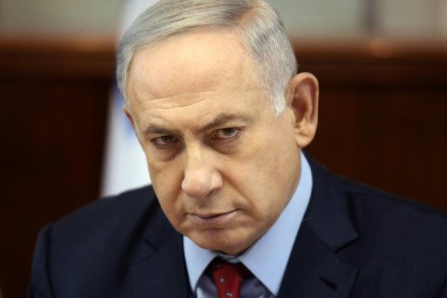 Israeli Prime Minister Benjamin Netanyahu looks on as he opens the weekly cabinet meeting