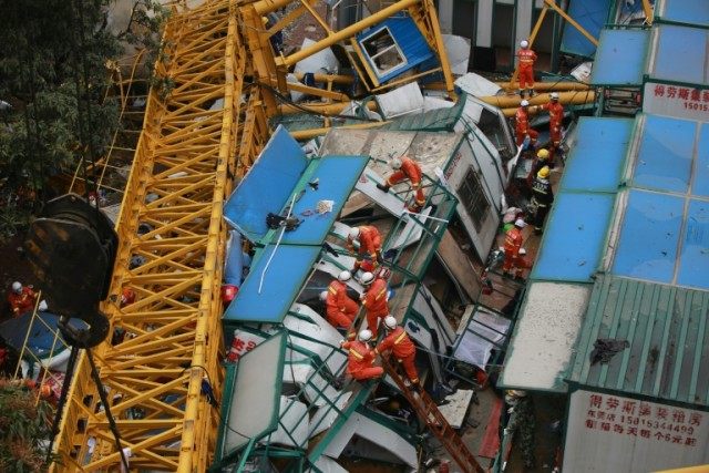 Rescuers work after a crane collapsed on a construction site in Mayong Township of Donggua