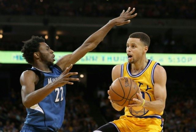 Golden State Warriors' Stephen Curry attempts to shoot as Minnesota Timberwolves' Andrew W