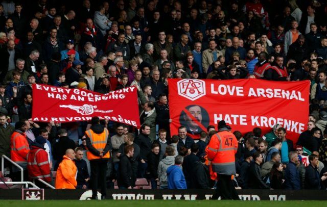 Arsenal fans display banners calling on manager Arsene Wenger to leave and showing their d