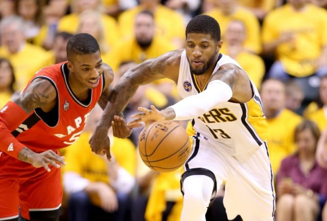 Paul George (R) of the Indiana Pacers battles for a loose ball with Delon Wright of the T