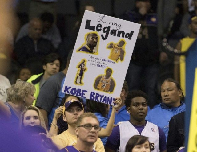 Basketball fans cheer for Kobe Bryant of the Los Angeles Lakers on April 22, 2016