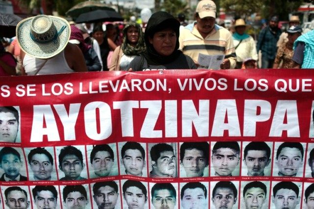Relatives of the 43 missing students from Ayotzinapa take part in a protest in Chilpancing