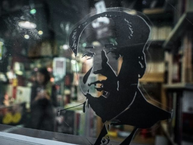 A sticker depicting Chairman Mao Zedong is seen on the door of a book store selling magazi