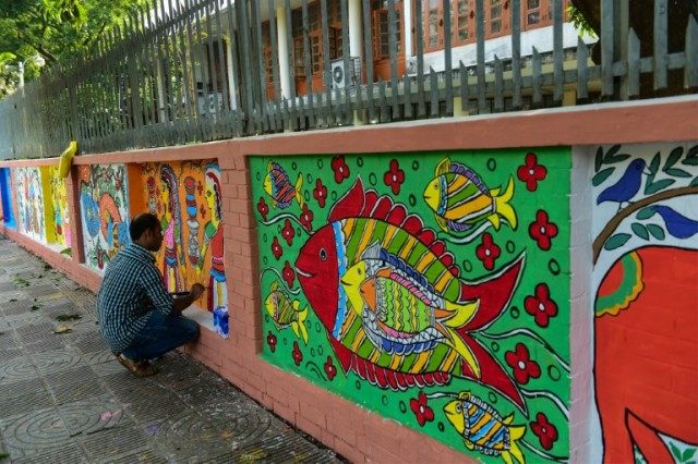 A Bangladeshi Dhaka University Art Institute student paints a mural as a part of Bengali N