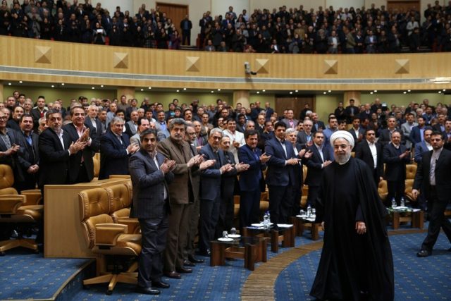 Iranian President Hassan Rouhani leaving after delivering a speech during a conference ent