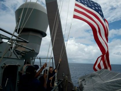US Navy personnel raise their flag during a bilateral maritime exercise with the Philippine Navy in the South China Sea in 2014